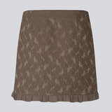 Elegant and feminine short skirt in luxurious fabric with beautiful texture and pattern. The Briannamd Skirt features a flattering A-line silhouette with decorative ruffle trim and a discreet zip closure. Made from 100% recycled polyester.