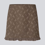 Elegant and feminine short skirt in luxurious fabric with beautiful texture and pattern. The Briannamd Skirt features a flattering A-line silhouette with decorative ruffle trim and a discreet zip closure. Made from 100% recycled polyester.