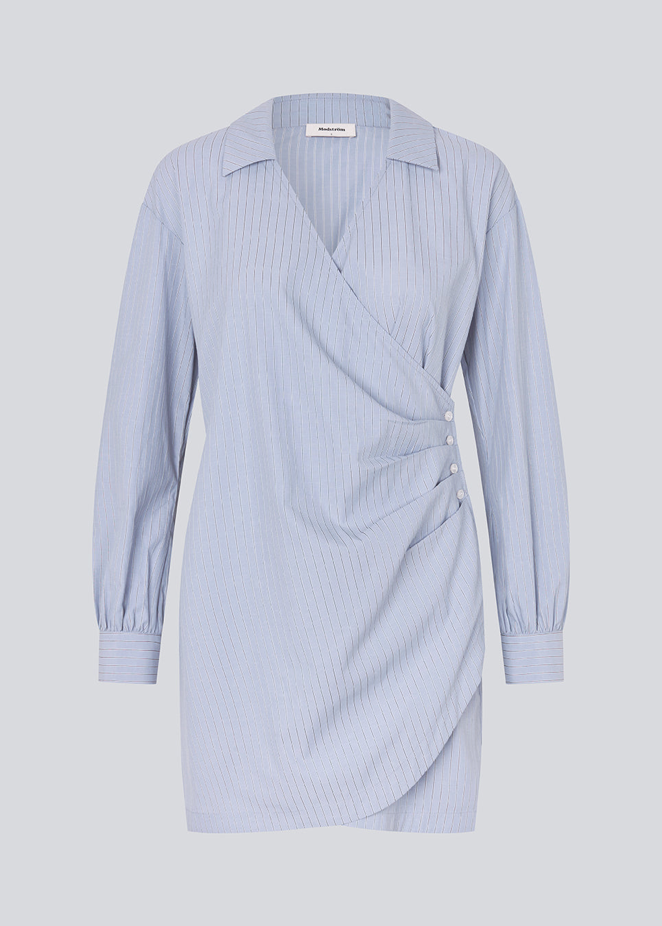 Short asymmetric dress with shirt-inspired details. The BrodieMD Dress features a collar, V-neckline, cuffs, and a wrap-style detail with buttons and pleats - a trendy and flattering style that creates a modern, effortless look.