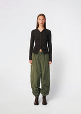 Relaxed trousers with a modern balloon silhouette. Caishamd pants are crafted from a lightweight fabric with an elasticated paperbag waistband and adjustable drawstring for a comfortable fit. The wide legs are gathered with elastic at the ankles, creating a voluminous, contemporary shape. Designed with slanted side pockets and a single welt pocket at the back, they combine functionality with a clean, minimal look. Pair them with a shirt or a lightweight knit for effortless everyday and weekend styling.