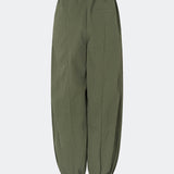 Relaxed trousers with a modern balloon silhouette. Caishamd pants are crafted from a lightweight fabric with an elasticated paperbag waistband and adjustable drawstring for a comfortable fit. The wide legs are gathered with elastic at the ankles, creating a voluminous, contemporary shape. Designed with slanted side pockets and a single welt pocket at the back, they combine functionality with a clean, minimal look. Pair them with a shirt or a lightweight knit for effortless everyday and weekend styling.