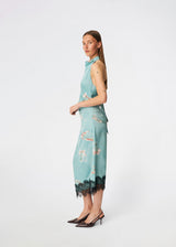 Elegant maxi dress featuring an artistic print and feminine details. Carinamd print dress is crafted from a lightweight, smooth fabric with a high halterneck neckline that fastens at the back of the neck and a self-tie belt at the waist to define the silhouette. The long, flowing fit is finished with a contrasting lace trim at the hem, adding a refined and romantic touch. A standout dress, perfect for summer parties, weddings, and other special occasions.