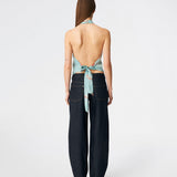 Elegant halterneck top featuring an artistic print and a feminine silhouette. Carinamd print top is crafted from a lightweight, smooth fabric with a high halterneck neckline that fastens at the back of the neck and a tie detail at the back for an adjustable fit. The softly draped design and unique print make it a standout piece for special occasions as well as elevated summer styling.