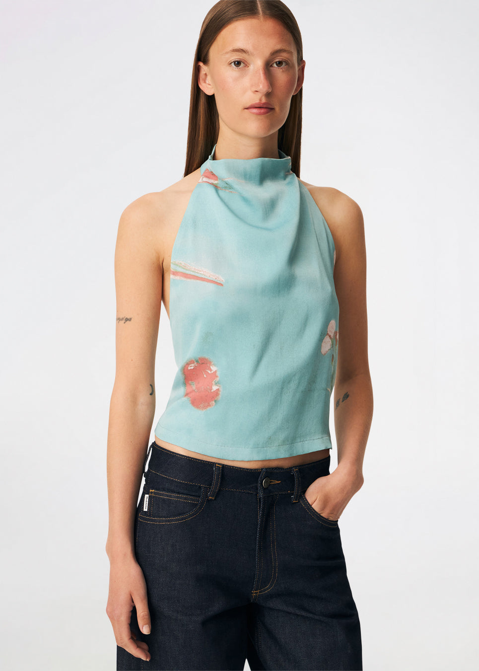 Elegant halterneck top featuring an artistic print and a feminine silhouette. Carinamd print top is crafted from a lightweight, smooth fabric with a high halterneck neckline that fastens at the back of the neck and a tie detail at the back for an adjustable fit. The softly draped design and unique print make it a standout piece for special occasions as well as elevated summer styling.