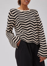 Jumper in beige with black stripes in crocheted style made from a soft organic cotton. CaryMD o-neck has a relaxed fit with a round neck with wavy hem, long wide sleeves and detailed finishes. The model is 175 cm and wears a size S/36.