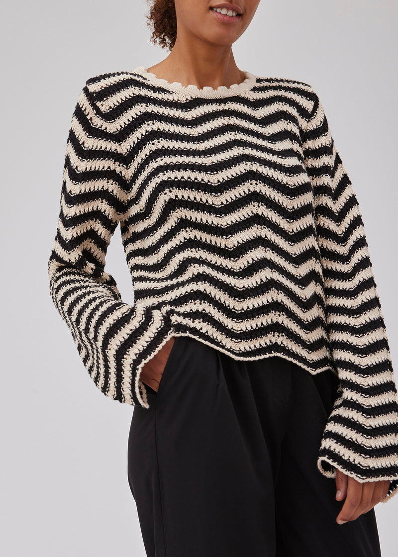 Jumper in beige with black stripes in crocheted style made from a soft organic cotton. CaryMD o-neck has a relaxed fit with a round neck with wavy hem, long wide sleeves and detailed finishes. The model is 175 cm and wears a size S/36.