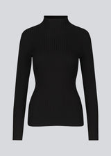 Slim fitted black long sleeved top in a stretchy rib knit with a high neck. Made from more responsible materials.  The model is 177 cm and wears a size S/36.