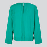 ChristopherMD top in green has a regular body with a round neck with gatherings, and small opening with button closure in the back. Long, wide sleeves. The model is 175 cm and wears a size S/36.