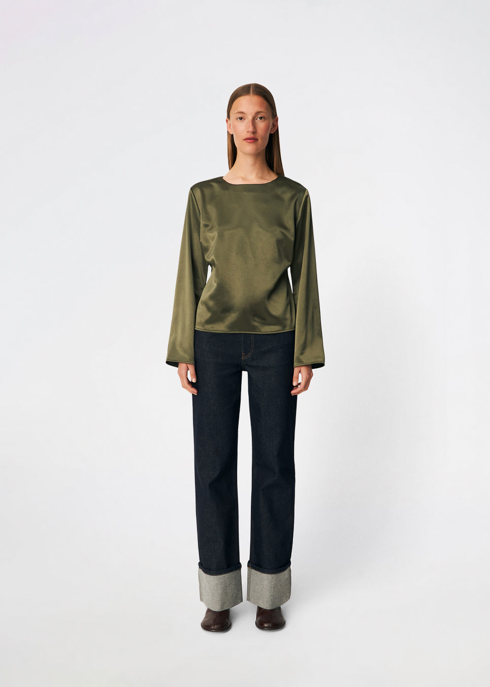 Elegant satin blouse with a feminine and contemporary look. Cianomd top is crafted from a lustrous satin fabric with long sleeves, a boat neckline, and a striking open-back detail finished with delicate tie fastening. A refined wardrobe staple that pairs effortlessly with tailored trousers, denim, or occasion-ready skirts.