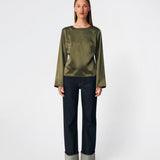Elegant satin blouse with a feminine and contemporary look. Cianomd top is crafted from a lustrous satin fabric with long sleeves, a boat neckline, and a striking open-back detail finished with delicate tie fastening. A refined wardrobe staple that pairs effortlessly with tailored trousers, denim, or occasion-ready skirts.