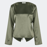 Elegant satin blouse with a feminine and contemporary look. Cianomd top is crafted from a lustrous satin fabric with long sleeves, a boat neckline, and a striking open-back detail finished with delicate tie fastening. A refined wardrobe staple that pairs effortlessly with tailored trousers, denim, or occasion-ready skirts.