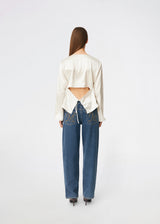 Elegant satin blouse with a feminine and contemporary look. Cianomd top is crafted from a lustrous satin fabric with long sleeves, a boat neckline, and a striking open-back detail finished with delicate tie fastening. A refined wardrobe staple that pairs effortlessly with tailored trousers, denim, or occasion-ready skirts.