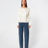 Elegant satin blouse with a feminine and contemporary look. Cianomd top is crafted from a lustrous satin fabric with long sleeves, a boat neckline, and a striking open-back detail finished with delicate tie fastening. A refined wardrobe staple that pairs effortlessly with tailored trousers, denim, or occasion-ready skirts.