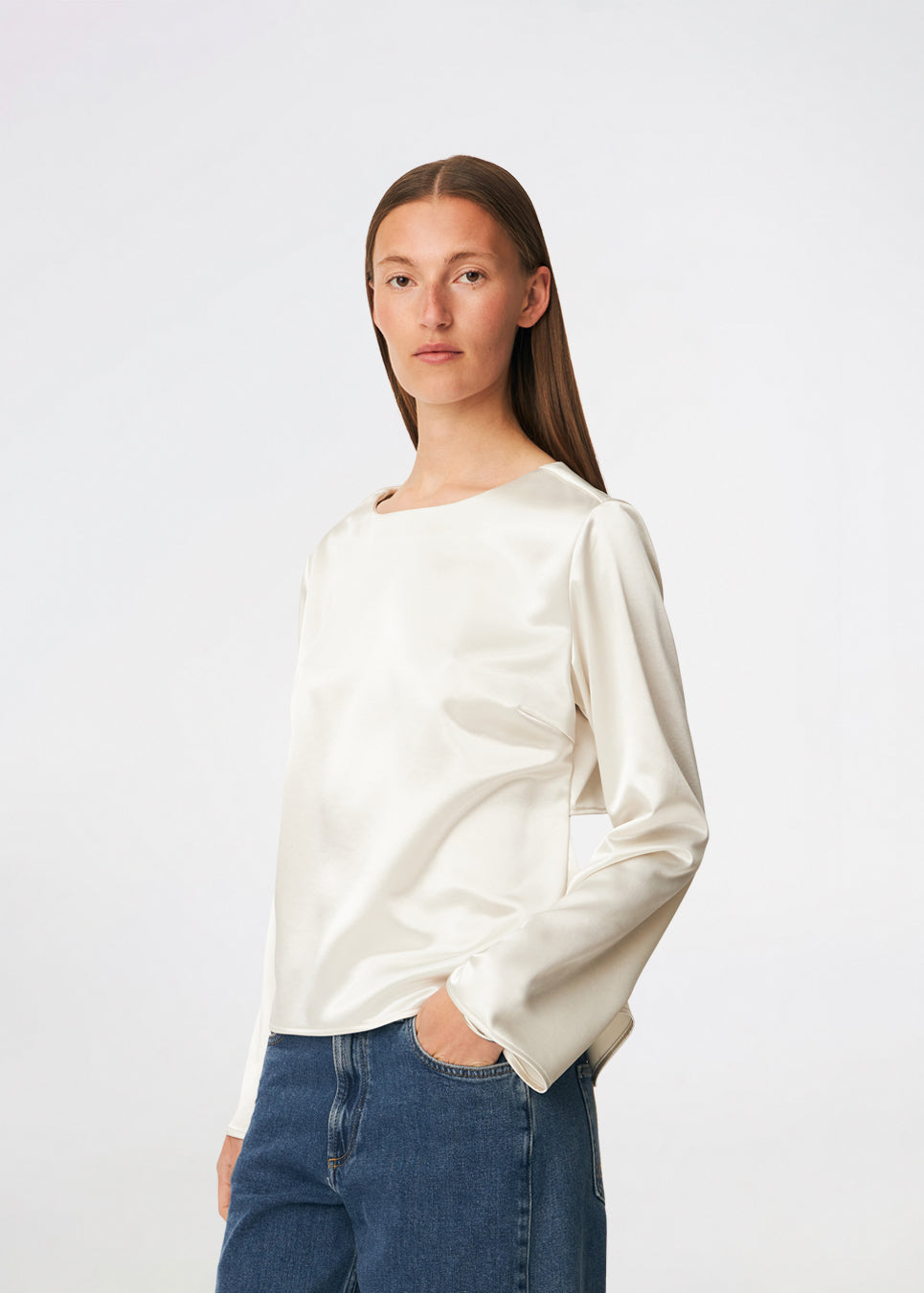 Elegant satin blouse with a feminine and contemporary look. Cianomd top is crafted from a lustrous satin fabric with long sleeves, a boat neckline, and a striking open-back detail finished with delicate tie fastening. A refined wardrobe staple that pairs effortlessly with tailored trousers, denim, or occasion-ready skirts.