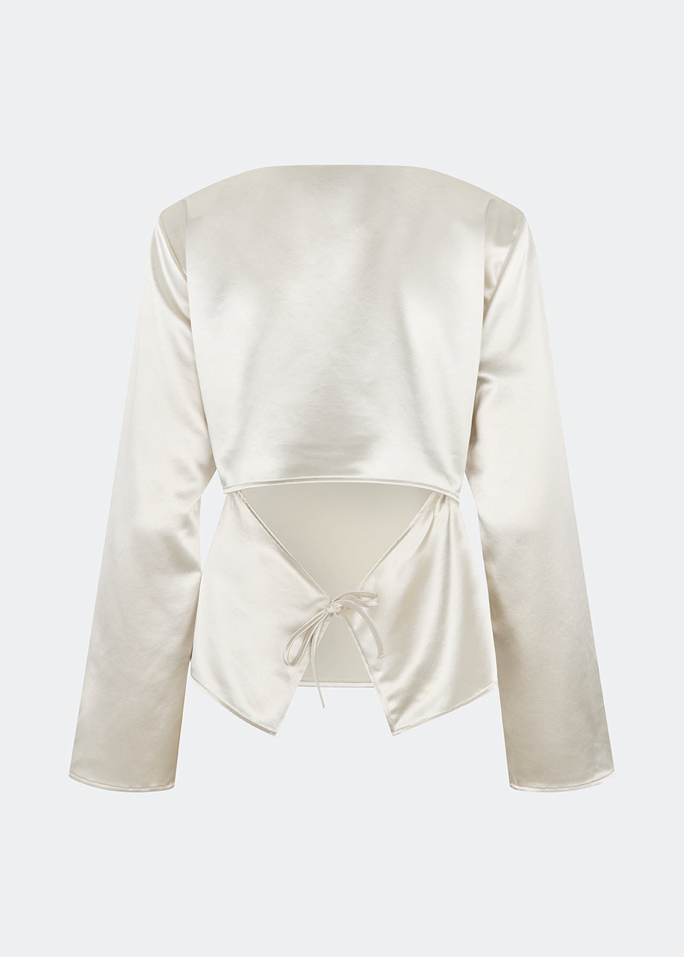 Elegant satin blouse with a feminine and contemporary look. Cianomd top is crafted from a lustrous satin fabric with long sleeves, a boat neckline, and a striking open-back detail finished with delicate tie fastening. A refined wardrobe staple that pairs effortlessly with tailored trousers, denim, or occasion-ready skirts.