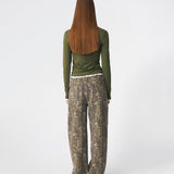 Long-sleeved T-shirt crafted from a soft and comfortable fabric. CiljaMD LS T-shirt features a fitted silhouette with a crew neckline and contrasting trims at the neckline, cuffs, and hem, creating a layered look. The delicate lettuce-edge finish adds a feminine touch, making it perfect to wear on its own or layered under knitwear, shirts, or jackets.