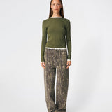 Long-sleeved T-shirt crafted from a soft and comfortable fabric. CiljaMD LS T-shirt features a fitted silhouette with a crew neckline and contrasting trims at the neckline, cuffs, and hem, creating a layered look. The delicate lettuce-edge finish adds a feminine touch, making it perfect to wear on its own or layered under knitwear, shirts, or jackets.