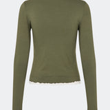 Long-sleeved T-shirt crafted from a soft and comfortable fabric. CiljaMD LS T-shirt features a fitted silhouette with a crew neckline and contrasting trims at the neckline, cuffs, and hem, creating a layered look. The delicate lettuce-edge finish adds a feminine touch, making it perfect to wear on its own or layered under knitwear, shirts, or jackets.