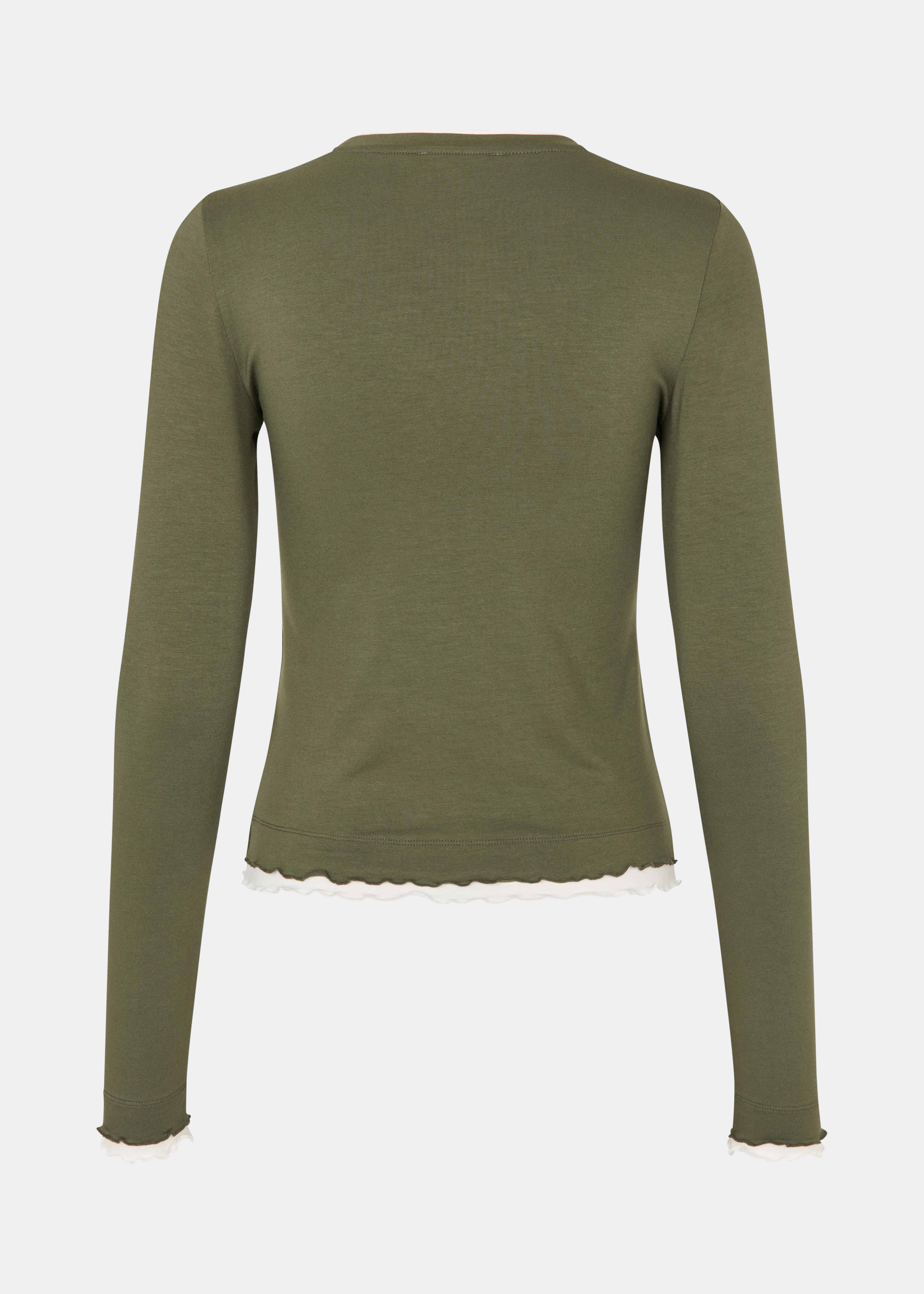 Long-sleeved T-shirt crafted from a soft and comfortable fabric. CiljaMD LS T-shirt features a fitted silhouette with a crew neckline and contrasting trims at the neckline, cuffs, and hem, creating a layered look. The delicate lettuce-edge finish adds a feminine touch, making it perfect to wear on its own or layered under knitwear, shirts, or jackets.