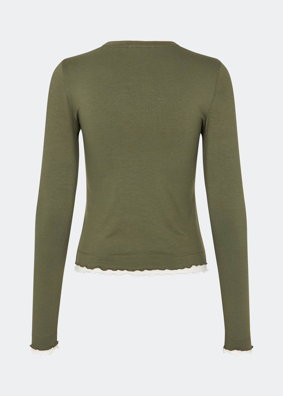 Long-sleeved T-shirt crafted from a soft and comfortable fabric. CiljaMD LS T-shirt features a fitted silhouette with a crew neckline and contrasting trims at the neckline, cuffs, and hem, creating a layered look. The delicate lettuce-edge finish adds a feminine touch, making it perfect to wear on its own or layered under knitwear, shirts, or jackets.