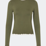Long-sleeved T-shirt crafted from a soft and comfortable fabric. CiljaMD LS T-shirt features a fitted silhouette with a crew neckline and contrasting trims at the neckline, cuffs, and hem, creating a layered look. The delicate lettuce-edge finish adds a feminine touch, making it perfect to wear on its own or layered under knitwear, shirts, or jackets.