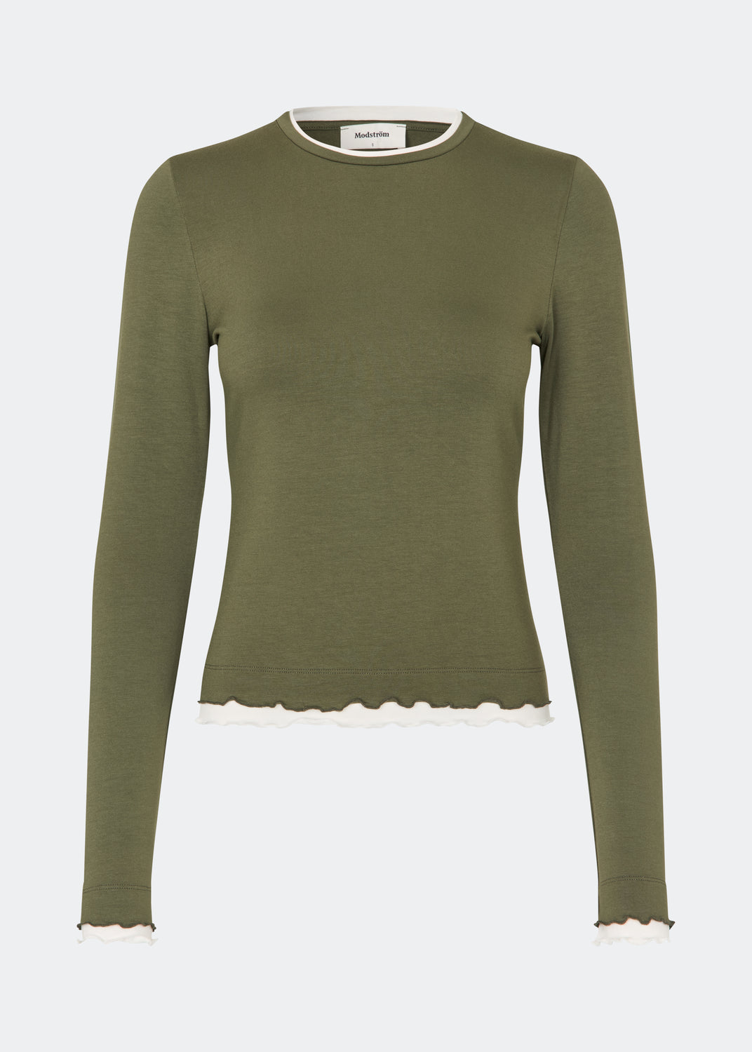 Long-sleeved T-shirt crafted from a soft and comfortable fabric. CiljaMD LS T-shirt features a fitted silhouette with a crew neckline and contrasting trims at the neckline, cuffs, and hem, creating a layered look. The delicate lettuce-edge finish adds a feminine touch, making it perfect to wear on its own or layered under knitwear, shirts, or jackets.