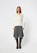 Soft and feminine knitted sweater with delicate crochet detailing. Cillamd V-neck is designed in a relaxed fit with a V-neckline, wide collar, and decorative crochet panels across the shoulders for a romantic touch. The voluminous sleeves and soft knit quality make it a comfortable wardrobe favourite that pairs effortlessly with jeans, tailored trousers, and skirts.