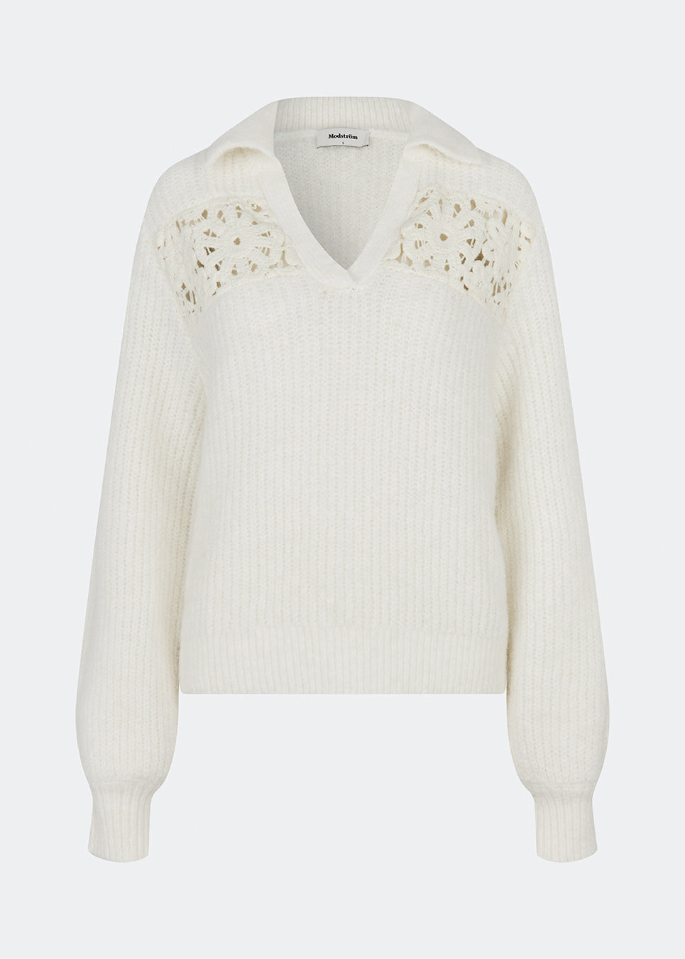Soft and feminine knitted sweater with delicate crochet detailing. Cillamd V-neck is designed in a relaxed fit with a V-neckline, wide collar, and decorative crochet panels across the shoulders for a romantic touch. The voluminous sleeves and soft knit quality make it a comfortable wardrobe favourite that pairs effortlessly with jeans, tailored trousers, and skirts.