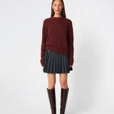 Pleated mini skirt with a modern, preppy aesthetic. Cirkelinemd skirt features a low-rise waist with a wrap-inspired design, decorative strap detail, and crisp pleats that create beautiful movement and volume. The mini length and tailored silhouette make it a versatile piece for both everyday styling and more elevated occasions. Pair it with a shirt, knitwear, or a simple top for a timeless look.