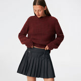 Pleated mini skirt with a modern, preppy aesthetic. Cirkelinemd skirt features a low-rise waist with a wrap-inspired design, decorative strap detail, and crisp pleats that create beautiful movement and volume. The mini length and tailored silhouette make it a versatile piece for both everyday styling and more elevated occasions. Pair it with a shirt, knitwear, or a simple top for a timeless look.