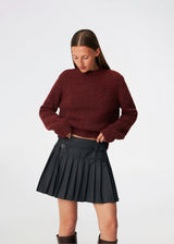 Pleated mini skirt with a modern, preppy aesthetic. Cirkelinemd skirt features a low-rise waist with a wrap-inspired design, decorative strap detail, and crisp pleats that create beautiful movement and volume. The mini length and tailored silhouette make it a versatile piece for both everyday styling and more elevated occasions. Pair it with a shirt, knitwear, or a simple top for a timeless look.