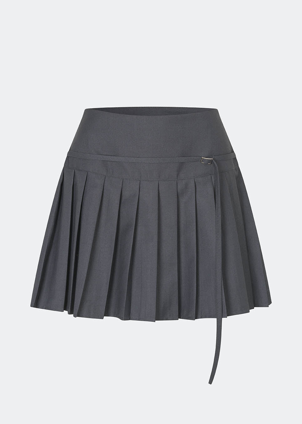 Pleated mini skirt with a modern, preppy aesthetic. Cirkelinemd skirt features a low-rise waist with a wrap-inspired design, decorative strap detail, and crisp pleats that create beautiful movement and volume. The mini length and tailored silhouette make it a versatile piece for both everyday styling and more elevated occasions. Pair it with a shirt, knitwear, or a simple top for a timeless look.