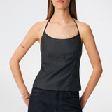 Elegant halterneck top with a modern look. Cirkelinemd top is made from 80% recycled polyester and designed with a flattering fit, a halterneck neckline, and a striking open back with adjustable straps. The feminine silhouette makes it perfect for both special occasions and elevated everyday styling.