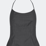 Elegant halterneck top with a modern look. Cirkelinemd top is made from 80% recycled polyester and designed with a flattering fit, a halterneck neckline, and a striking open back with adjustable straps. The feminine silhouette makes it perfect for both special occasions and elevated everyday styling.
