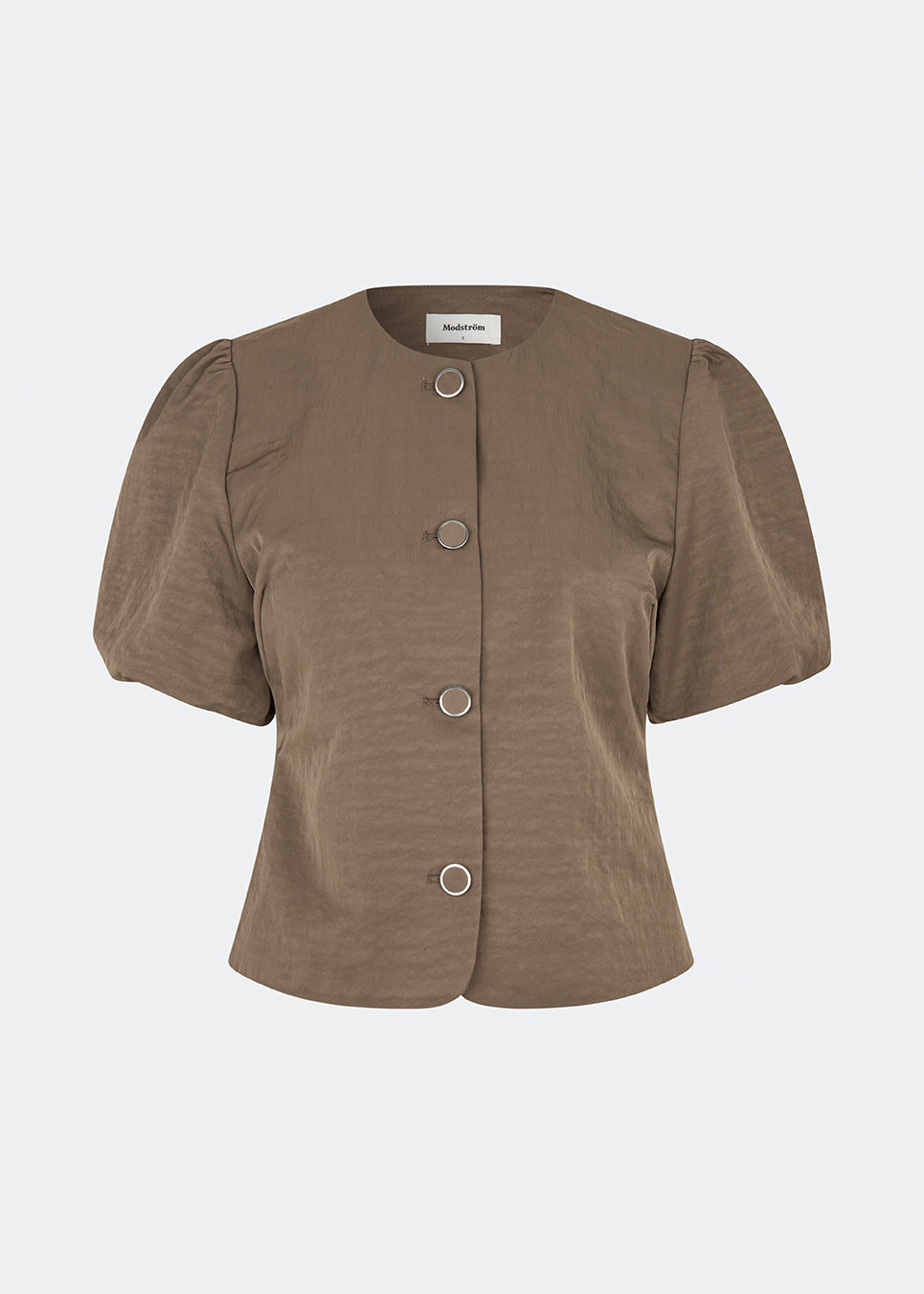 Short-sleeved blazer with a feminine, tailored silhouette. The CirkelMD SS Blazer features a round neckline, short voluminous puff sleeves, and decorative front button closure. Crafted in a lightly textured fabric, it can be worn as both a top and a lightweight jacket, making it ideal for special occasions or an elevated everyday look.