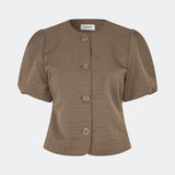 Short-sleeved blazer with a feminine, tailored silhouette. The CirkelMD SS Blazer features a round neckline, short voluminous puff sleeves, and decorative front button closure. Crafted in a lightly textured fabric, it can be worn as both a top and a lightweight jacket, making it ideal for special occasions or an elevated everyday look.