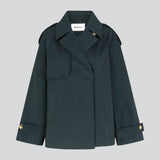 Short trench coat in dar blue in a cotton quality with concealed buttons down the front. Clara jacket has an oversized silhouette and classic details. Lined.