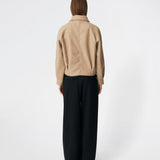 Short jacket with a timeless, sophisticated aesthetic. Cleamd jacket features a relaxed, slightly boxy silhouette with a double-breasted button closure, classic collar, and raglan sleeves for a soft and comfortable fit. Discreet side pockets and clean lines enhance the minimalist design, while the cropped length makes it perfect for both everyday wear and more polished looks.