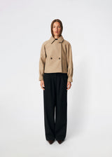 Short jacket with a timeless, sophisticated aesthetic. Cleamd jacket features a relaxed, slightly boxy silhouette with a double-breasted button closure, classic collar, and raglan sleeves for a soft and comfortable fit. Discreet side pockets and clean lines enhance the minimalist design, while the cropped length makes it perfect for both everyday wear and more polished looks.