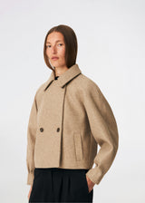 Short jacket with a timeless, sophisticated aesthetic. Cleamd jacket features a relaxed, slightly boxy silhouette with a double-breasted button closure, classic collar, and raglan sleeves for a soft and comfortable fit. Discreet side pockets and clean lines enhance the minimalist design, while the cropped length makes it perfect for both everyday wear and more polished looks.