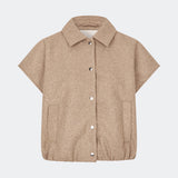 Short vest with a modern, relaxed aesthetic. Cleamd vest features a boxy silhouette with short, wide sleeves, a classic collar, and snap button closure at the front. Discreet front pockets and an elasticated hem create a soft, rounded shape and a comfortable fit. Perfect for layering over knitwear, shirts, or dresses during the transitional seasons.