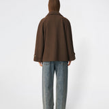 Short double-breasted wool-blend jacket with a wide lapel collar, buttoned cuff straps and raglan sleeves that create a rounded shoulder line. Wear it with denim or a fluid skirt. The model is 175 cm tall and is wearing a size S/36.