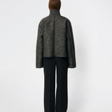 Short faux shearling jacket with a modern, timeless aesthetic. Coralinemd jacket features a relaxed silhouette with a high stand collar, front button closure, and decorative seam detailing that enhances its classic design. Soft teddy trims at the cuffs add warmth and contrast, while the slightly oversized fit makes it perfect for layering throughout the colder months.