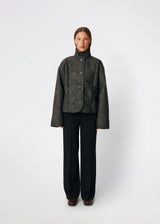 Short faux shearling jacket with a modern, timeless aesthetic. Coralinemd jacket features a relaxed silhouette with a high stand collar, front button closure, and decorative seam detailing that enhances its classic design. Soft teddy trims at the cuffs add warmth and contrast, while the slightly oversized fit makes it perfect for layering throughout the colder months.
