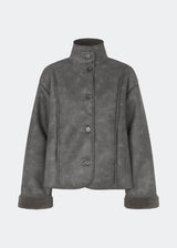 Short faux shearling jacket with a modern, timeless aesthetic. Coralinemd jacket features a relaxed silhouette with a high stand collar, front button closure, and decorative seam detailing that enhances its classic design. Soft teddy trims at the cuffs add warmth and contrast, while the slightly oversized fit makes it perfect for layering throughout the colder months.