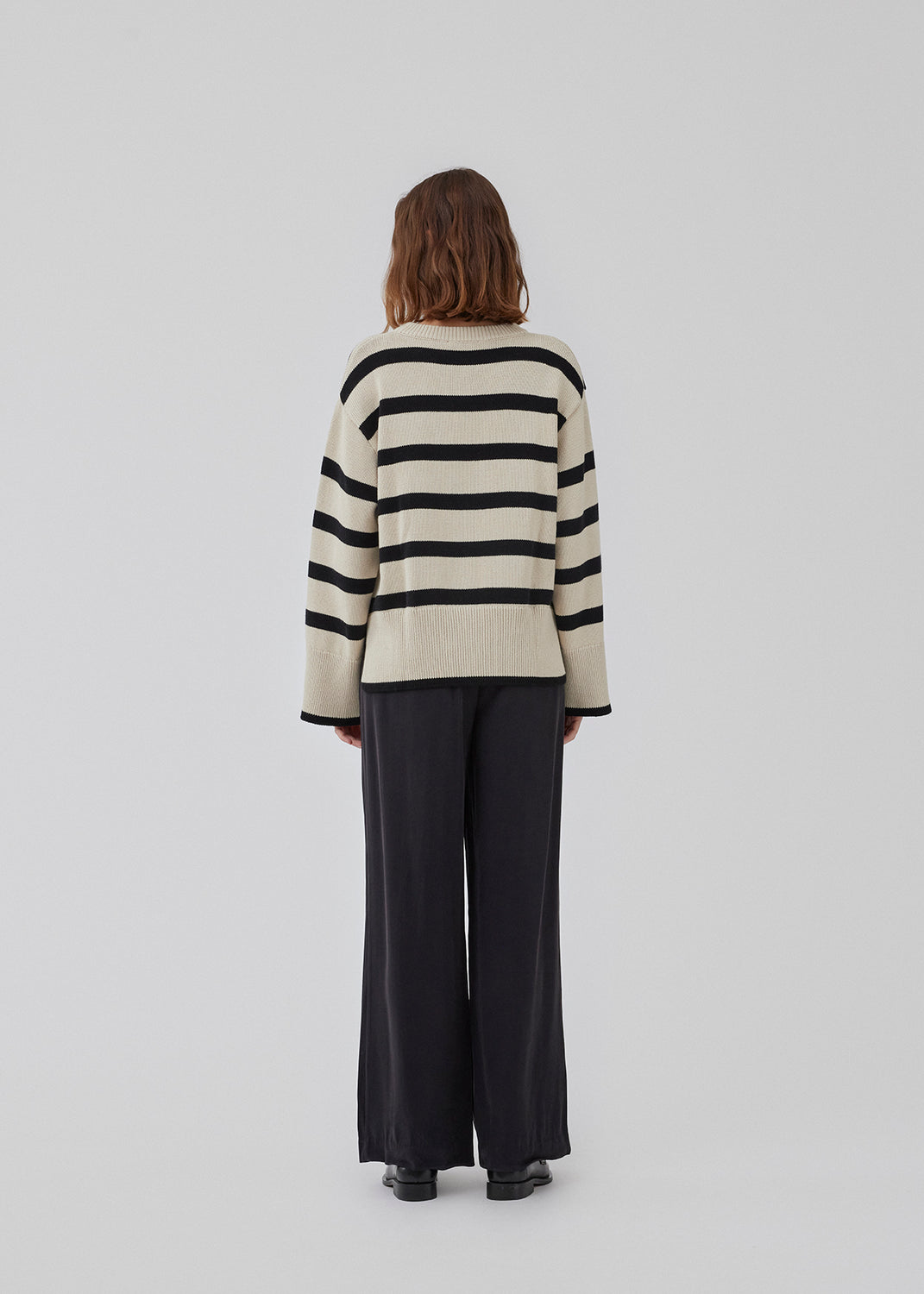 Fine-knitted oversized jumper knitted from cotton with black stripes. CorbinMD stripe o-neck has a ribbed round neckline, long wide sleeves, and wide ribbing at cuffs and hem.