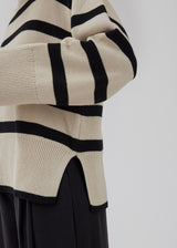 Fine-knitted oversized jumper knitted from cotton with black stripes. CorbinMD stripe o-neck has a ribbed round neckline, long wide sleeves, and wide ribbing at cuffs and hem.