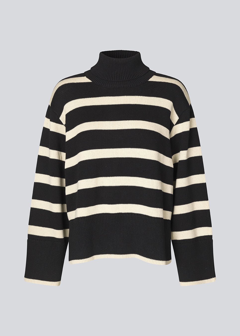 Fine-knitted oversized jumper knitted from cotton in black with beige stripes. CorbinMD stripe t-neck has a ribbed rollneck, long wide sleeves, and wide ribbing at cuffs and hem.  The model is 177 cm and wears a size S/36.