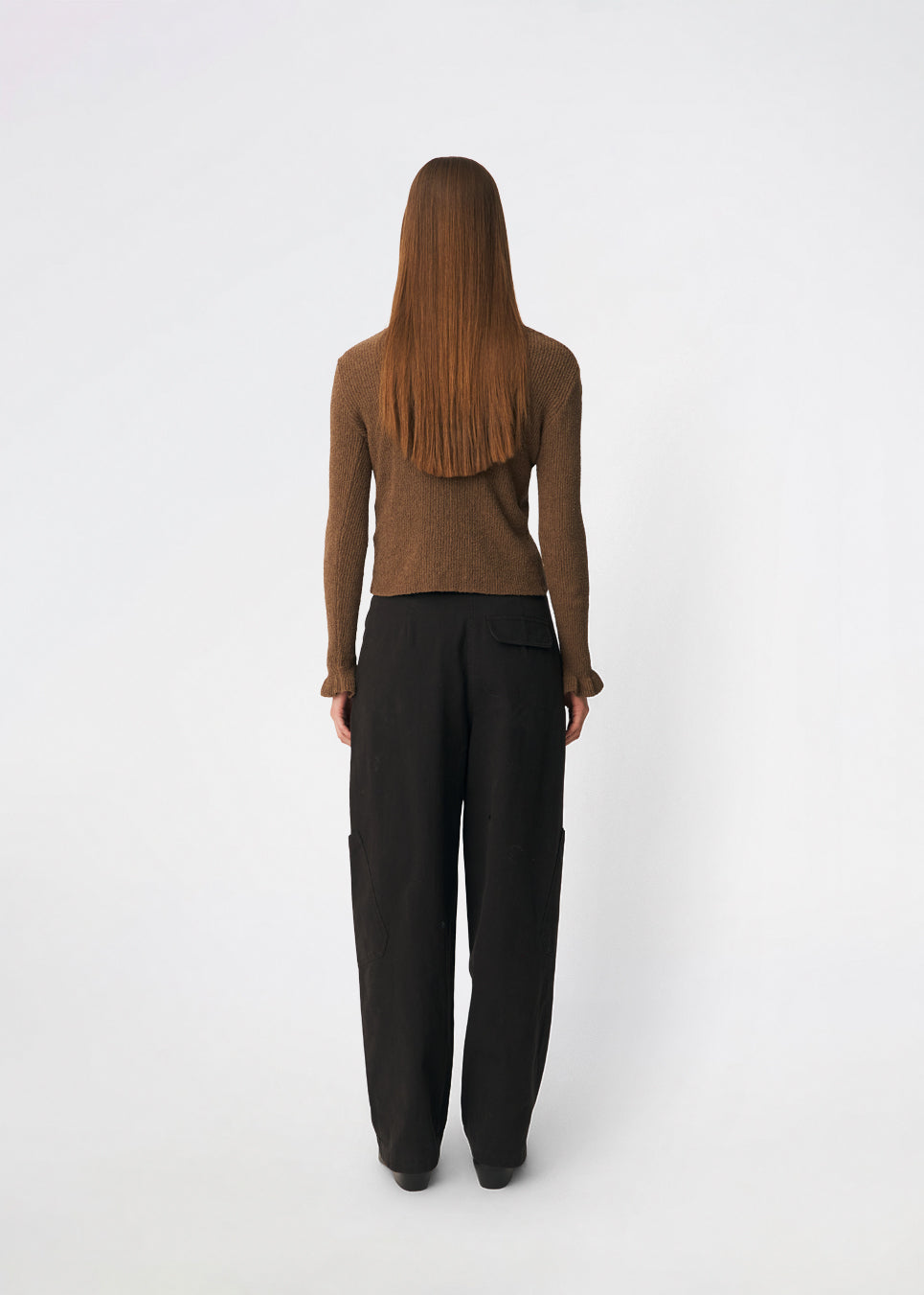 Feminine rib-knit cardigan with elegant details. Corneliamd cardigan is designed in a fitted silhouette with a classic collar, full button-front closure, and delicate ruffle trims at the cuffs. The soft rib-knit enhances the flattering fit, making it a versatile wardrobe staple that can be worn buttoned up as a knit top or layered open over a camisole or dress.