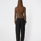 Feminine rib-knit cardigan with elegant details. Corneliamd cardigan is designed in a fitted silhouette with a classic collar, full button-front closure, and delicate ruffle trims at the cuffs. The soft rib-knit enhances the flattering fit, making it a versatile wardrobe staple that can be worn buttoned up as a knit top or layered open over a camisole or dress.